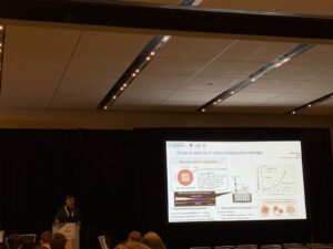 Dr Vasileios Vavourakis presenting a slide on in vitro to in silico melanoma therapy using an atmospheric pressure plasma jet, at the World Congress of Biomechanics 2026, Vancouver.